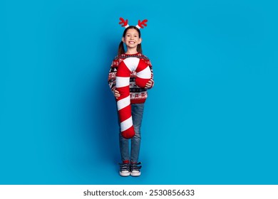 Photo of lovely cheerful nice girl wear red sweater christmas theme party hold big toy isolated on blue color background - Powered by Shutterstock