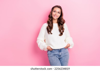 Photo of lovely cute lady beaming smile put hands pockets look empty space isolated on pink color background - Shutterstock ID 2256234819