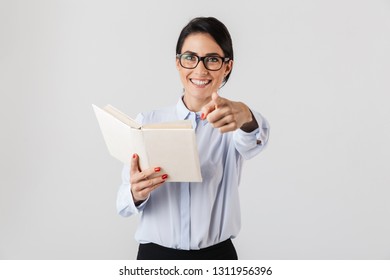 Photo of lovely female worker wearing eyeglasses reading book in the office isolated over white background
