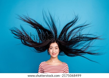 Photo of lovely funny lady dressed red shirt hair flying wind blowing isolated blue color background