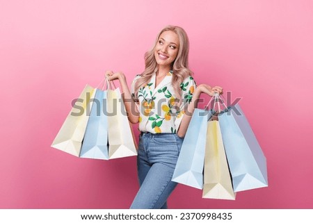 Photo of lovely girl with curly hairdo dressed flower print blouse holding new outfit look empty space isolated on pink color background