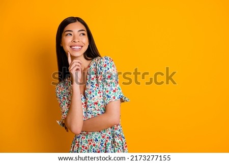 Photo of lovely girly female look blank space daydreaming thinking wear flowery dress isolated on yellow color background