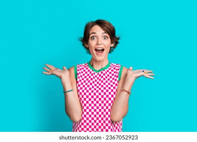 Photo of lovely optimistic girl wear plaid stylish clothes celebrating victory unbelievable offer isolated on cyan color background