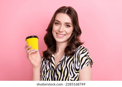 Photo of lovely positive girl beaming smile arm hold coffee cup isolated on pink color background
