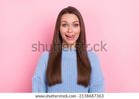 Photo of lovely young brown hairdo lady lick teeth wear blue pullover isolated on pink color background