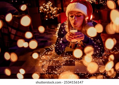 Photo of lovely young woman lying floor drink milk dressed christmas outfit tradition garland lights atmosphere decor house indoors room - Powered by Shutterstock