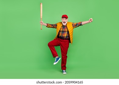 Photo Of Lucky Pretty Mature Man Dressed Yellow Waistcoat Smiling Playing Baseball Rising Fist Isolated Green Color Background