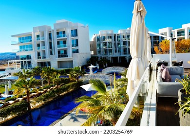 Photo Of A Luxury Tourist Resort With Swimming Pool And Palm-trees Near The Sea 