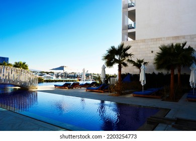 Photo Of A Luxury Tourist Resort With Swimming Pool And Palm-trees Near The Sea 