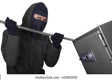 Photo Of A Male Burglar Using A Crowbar To Steal And Open A Safe-deposit Box, Isolated On White Background