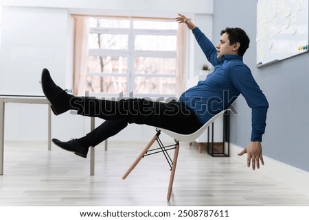 Photo Of Man Falling On Chair In Office