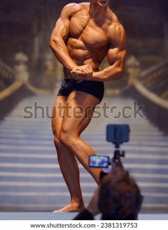 Photo, man flex in bodybuilder competition for fitness, professional or beauty pageant for sports or judge. Male person, people or muscular model pose in confidence, underwear or stage for contest