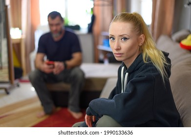 Photo Of A Man At Home Sitting With A Young Woman On The Sofa Without Talking Right In Front Of The Camera