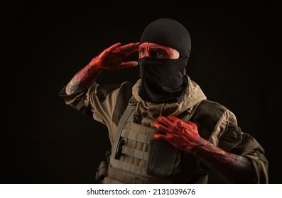 Photo Of A Man In A Military Uniform And Balaclava With A Bloody Face And Hands Up To The Elbow In Blood On A Black Background