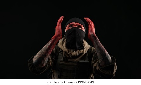 Photo Of A Man In A Military Uniform And Balaclava With A Bloody Face And Hands Up To The Elbow In Blood On A Black Background