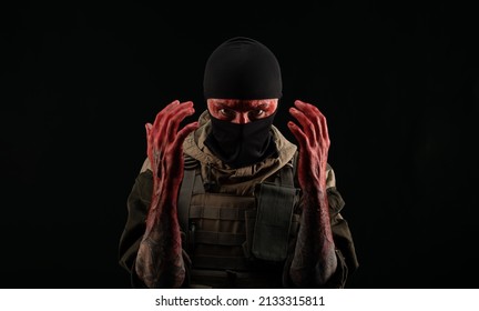 Photo Of A Man In A Military Uniform And Balaclava With A Bloody Face And Hands Up To The Elbow In Blood On A Black Background