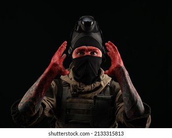 Photo Of A Man In A Military Uniform And Balaclava With A Bloody Face And Hands Up To The Elbow In Blood On A Black Background