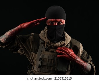 Photo Of A Man In A Military Uniform And Balaclava With A Bloody Face And Hands Up To The Elbow In Blood On A Black Background