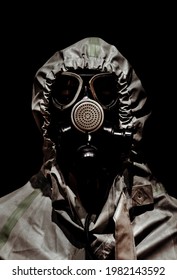 Photo Of A Man In Protective Chemical Rubber Gas Mask And Full Body Suit On Black Background.