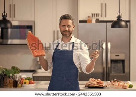 photo of man smile and cook delicacy salmon. man cook delicacy salmon.