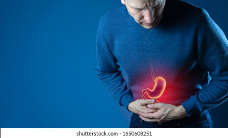 Photo Man Touching Stomach Painful Suffering From Stomachache Causes, Gastric Ulcer Or Gastrointestinal System Disease. Healthcare And Health Insurance Concept.