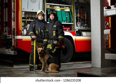 Photo Of Man, Woman And Dog Firefighter Near Fire Truck