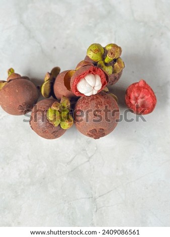 photo of mangosteen fruit on the white floor. Mangosteen fruit is rich in antioxidants