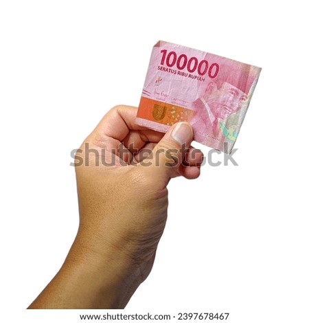 Photo of a man's hand showing a folded one hundred thousand rupiah banknote isolated on a white background