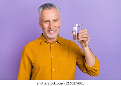 Photo of mature cheerful man drink fresh water health care morning isolated over violet color background - Powered by Shutterstock