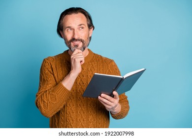 Photo Of Mature Happy Positive Good Mood Dreamy Man Reading Book Thinking Look Copyspace Isolated On Blue Color Background