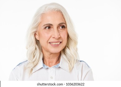 Photo of mature old happy woman standing isolated over white background looking aside. - Shutterstock ID 1036203622