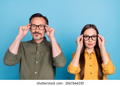 Photo Of Mature Serious Man And Woman People Wear Glasses Eyewear Hold Hands Isolated On Blue Color Background