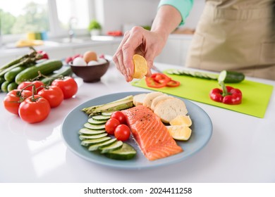 Photo Of Mature Woman Squeeze Lemon Juice Dish Cook Gourmet Salmon Vegetables Diet Cafe Delicious Food Indoors