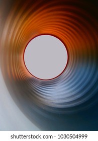 photo of a metal pipe with curves in a playground, view from the inside.  abstract lights and textures. for design. space for your text - Shutterstock ID 1030504999