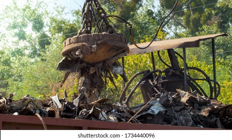 Photo of metal scrap and waste stcking to the electric magnet on dump