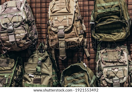 Photo of military store with different soldier and tactical backpacks stand.