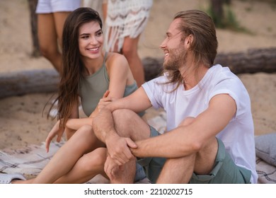 Photo Of Millennial Couple Sit Talk Wear Casual Cloth On The Beach