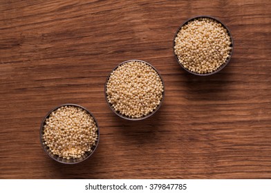 photo of millet in metal bowl on wooden table - Shutterstock ID 379847785