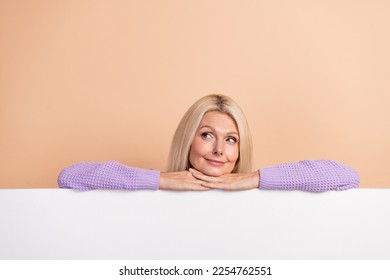 Photo of minded creative person look interested empty space proposition isolated on beige color background - Shutterstock ID 2254762551