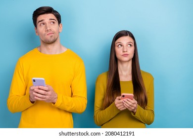 Photo of minded guy lady hold smart phone app think look empty space repost share news isolated over blue color background