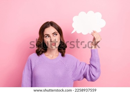 Photo of minded lovely cute lady blow lips wear trendy winter clothes hold empty space sms message isolated on pink color background
