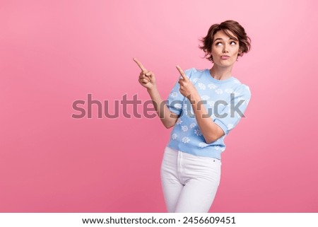 Photo of minded pretty lady look direct fingers empty space hesitate isolated on pink color background