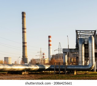 Photo Of A Modern Industrial Plant Outside The City. Metal And Heat Pipes. Manufacturing And Industry.