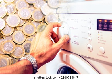 Photo Montage Showing A Man's Hand Turning A Washing Machine Wheel And Euro Coins Behind It. Concept Of Energy Cost.