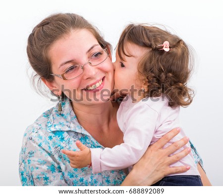 Photo of mother with daughter kissing and hugging