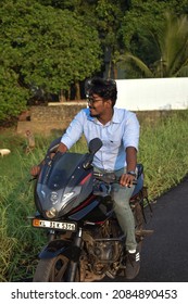  Photo Of A Motorcycle Rider Posing While Riding, Without Helmet. Location: Kerala, India Date 21-10-2020.