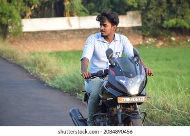  Photo Of A Motorcycle Rider Posing While Riding, Without Helmet. Location: Kerala, India Date 21-10-2020.