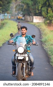  Photo Of A Motorcycle Rider Posing While Riding, Without Helmet. Location: Kerala, India Date 21-10-2020.