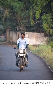  Photo Of A Motorcycle Rider Posing While Riding, Without Helmet. Location: Kerala, India Date 21-10-2020.