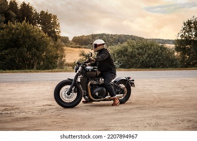 Photo Of A Motorcyclist At Sunset. Vintage Wallpaper. 60s Style Background
